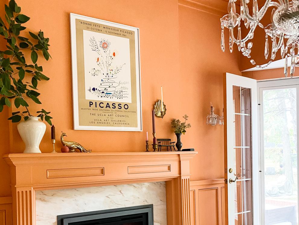 Fireplace gas insert in white surround with peach mantel and feature wall, and dog and pup sleeping on rug.