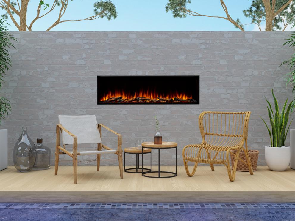 Poolside Lounge with Bamboo Chairs in front of linear fireplace with light colored brick Wall