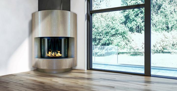 Stellar half-round custom fireplace with curved glass in brushed-steel casing set in room corner