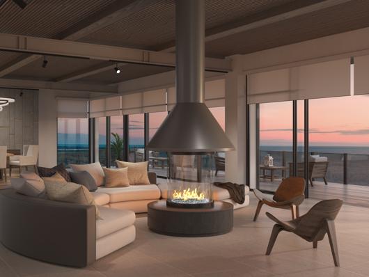 Custom round luxury gas fireplace in upscale lounge with dining area in background. 