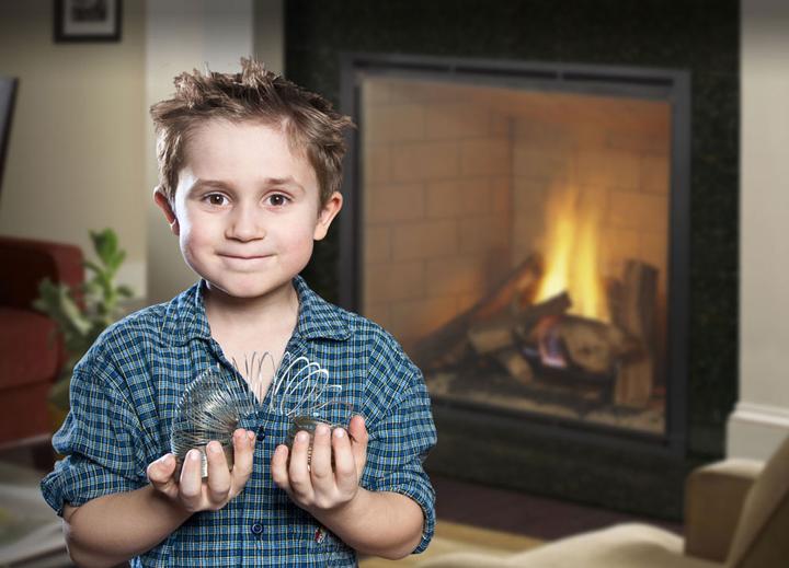 Child with slinky with fireplace in the background - fireplace safety